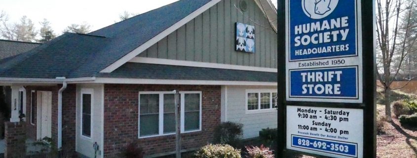 exterior view of a brick and tan siding building with a Blue Ridge Humane sign outside