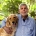 a man and dog pose together