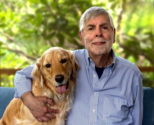 a man and dog pose together