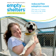 A person holds a medium white dog