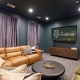 A couch in a room with a TV that says "The Highland"